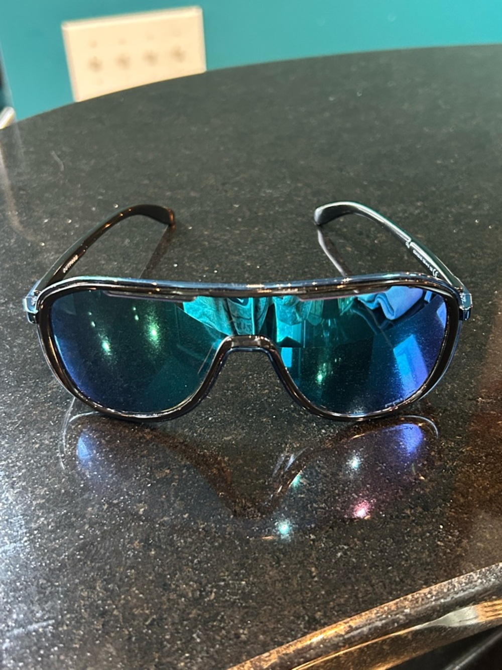 Oakley Black Frame Sunglasses with Blue-Green Mirrored Lenses